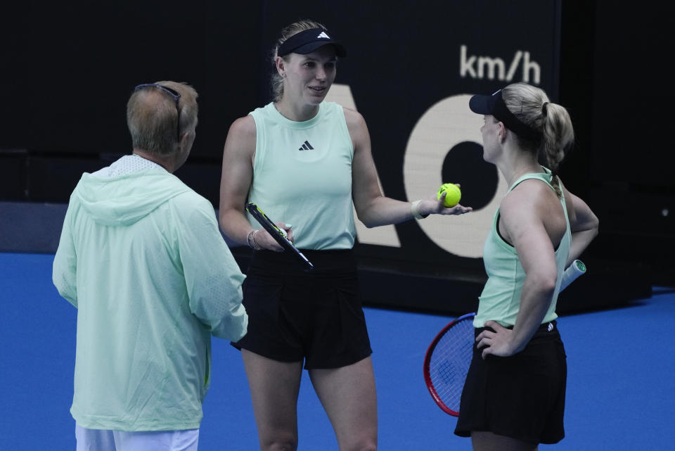 Denmark's Caroline Wozniacki and Germany's Angelique Kerber, right, talk during a practice session ahead of the Australian Open tennis championships at Melbourne Park, Melbourne, Australia, Friday, Jan. 12, 2024. (AP Photo/Andy Wong)