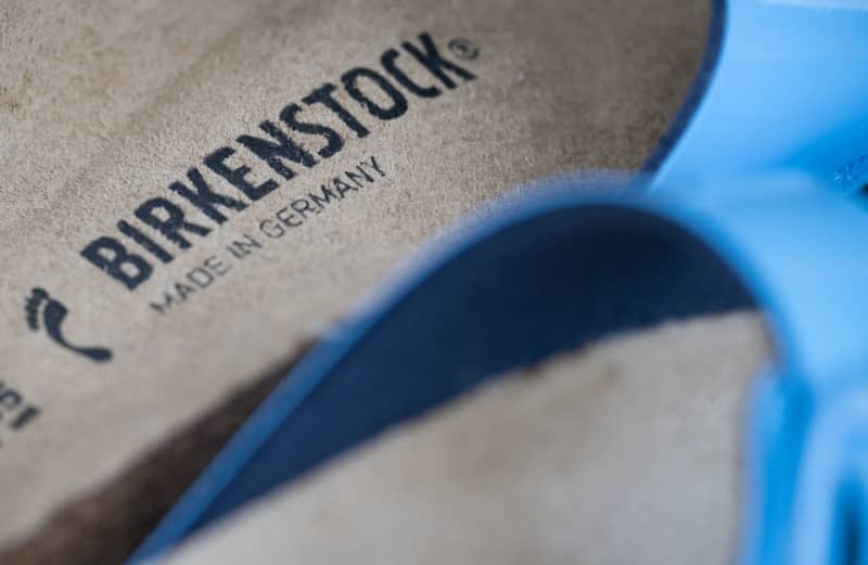 View of the Birkenstock logo on a sandal. German sandal maker Birkenstock is once again expecting a significant increase in sales for the current financial year, forecasting sales through September to rise by 17% to 18%. Sebastian Gollnow/dpa