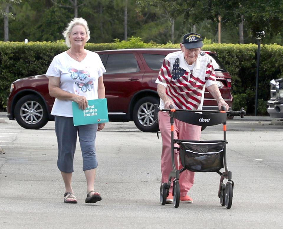 On the eve of his 103rd birthday, World War II veteran Ed Vrona and his daughter Vicki Boquist stroll toward his home in the Aberdeen At Ormond mobile home community in Ormond Beach. “Ed is a celebrity here,” said Cindy Miller, Aberdeen’s activities director. “Everybody loves Ed Vrona.”