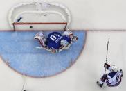 Team USA's Phil Kessel scores a goal on Slovenia's goalie Luka Gracnar during the first period of their men's preliminary round ice hockey game at the 2014 Sochi Winter Olympics, February 16, 2014. REUTERS/Brian Snyder (RUSSIA - Tags: OLYMPICS SPORT ICE HOCKEY TPX IMAGES OF THE DAY)