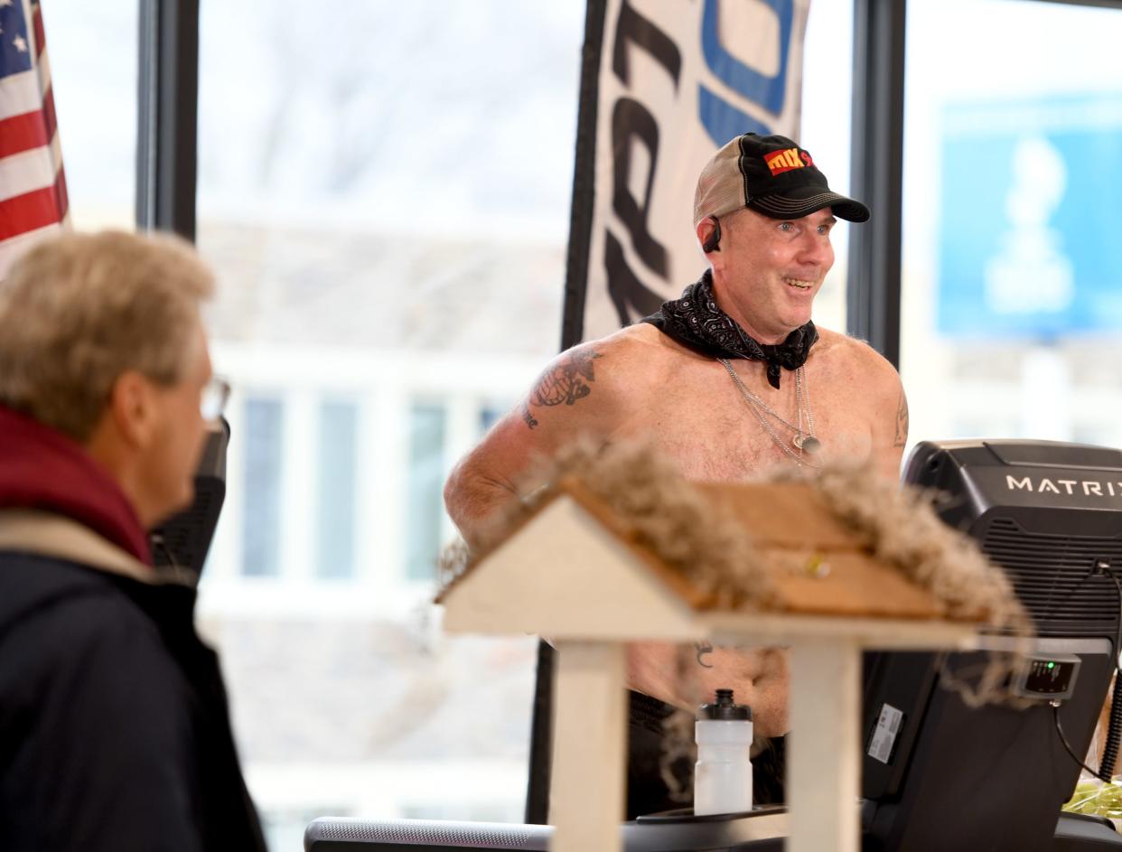 Marine veteran and recovering addict Bob Mohr, right, embarked on a 24-hour treadmill run starting Friday morning to raise money for Wishes Can Happen. The run-a-thon took place at Kempthorn Motors in Canton. Planet Fitness donated the treadmills.