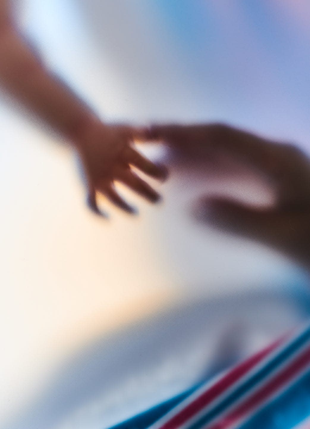 baby and mom grabbing hands