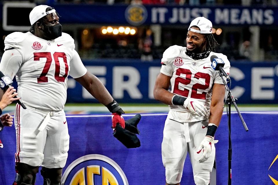 Alabama Crimson Tide offensive lineman Alex Leatherwood (70) and running back Najee Harris (22) are interviewed after beating the Florida Gators in the SEC Championship at Mercedes-Benz Stadium.