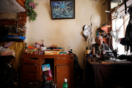 Ahmad Zarka, 73, a retired school worker, sits inside his shop in Aleppo's Kalasa district, Syria April 10, 2019. REUTERS/Omar Sanadiki