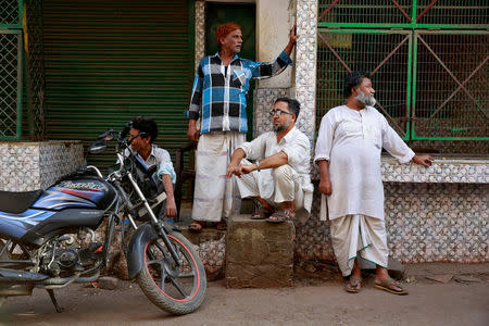 FILE PHOTO: Butchers from the Qureshi community gather outside meat shops ordered to close, following regulations imposed by newly elected Uttar Pradesh State Chief Minister, Yogi Adityanath, in Lucknow, India, April 4, 2017. REUTERS/Cathal McNaughton/File photo