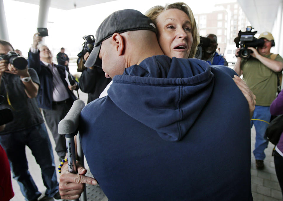 FILE - In this May 14, 2013 file photo, Boston Marathon bombing survivor Roseann Sdoia, from the North End neighborhood of Boston, is hugged and lifted off the ground by Boston firefighter Mike Meteria as she leaves Spaulding Rehabilitation Hospital in Boston. Meteria was part of a group of first responders who brought Sdoia to the hospital after she lost part of her right leg in an explosion near the race's finish line. The same first responders were on hand for Sdoia's departure from the Boston hospital. (AP Photo/Charles Krupa, File)