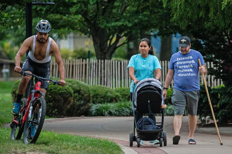 Visitors ride and stroll along the Wilmington Riverwalk, Thursday, Aug. 17, 2023. The Riverwalk is 1.75 miles long.