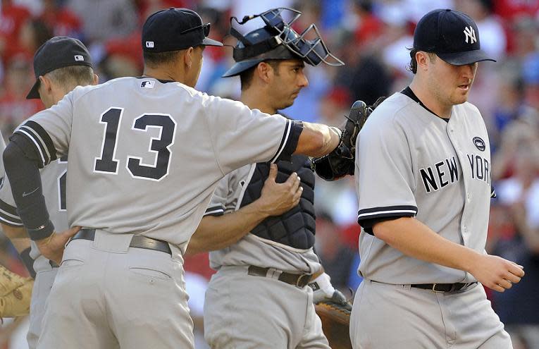 Alex Rodriguez pats Phil Hughes on the back as he leaves Game 2 of the 2010 ALCS against the Rangers . (Getty Images) 