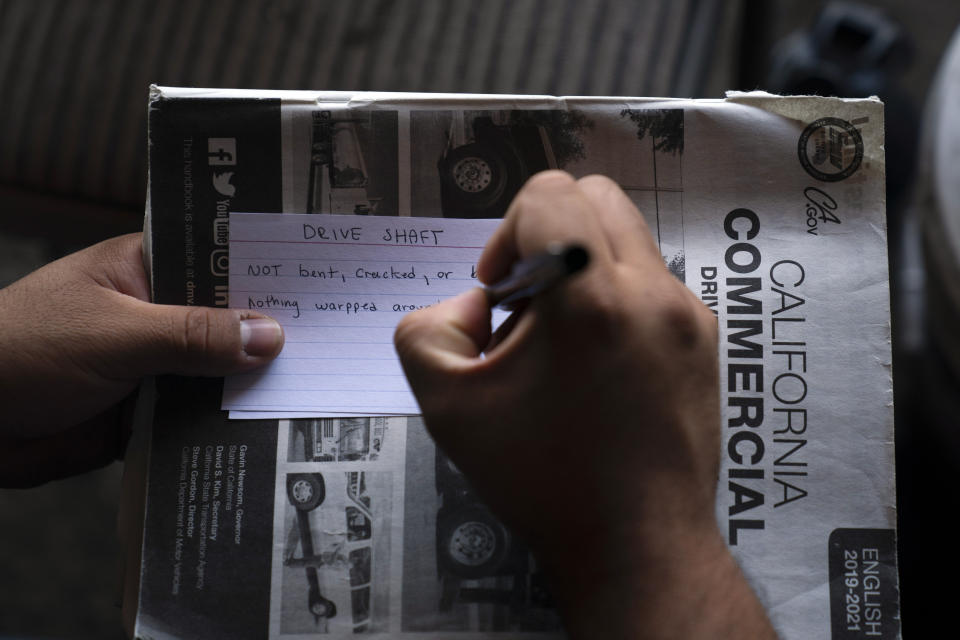 Sammy Martinez, 27, makes flash cards for his commercial driver's license exam while taking a class at California Truck Driving Academy in Inglewood, Calif., Monday, Nov. 15, 2021. Amid a shortage of commercial truck drivers across the U.S., a Southern California truck driving school sees an unprecedented increase in enrollment numbers. The increase is big enough that the school is starting an evening class to meet the demand, according to Tina Singh, owner and academy director of California Truck Driving Academy. "I think that's only going to continue because there's a lot of job opportunities. We have over 100 active jobs on our job board right now," said Singh. The companies that normally would not hire drivers straight out of school are "100 percent" willing to hire them due to shortage issues, the director added. (AP Photo/Jae C. Hong)