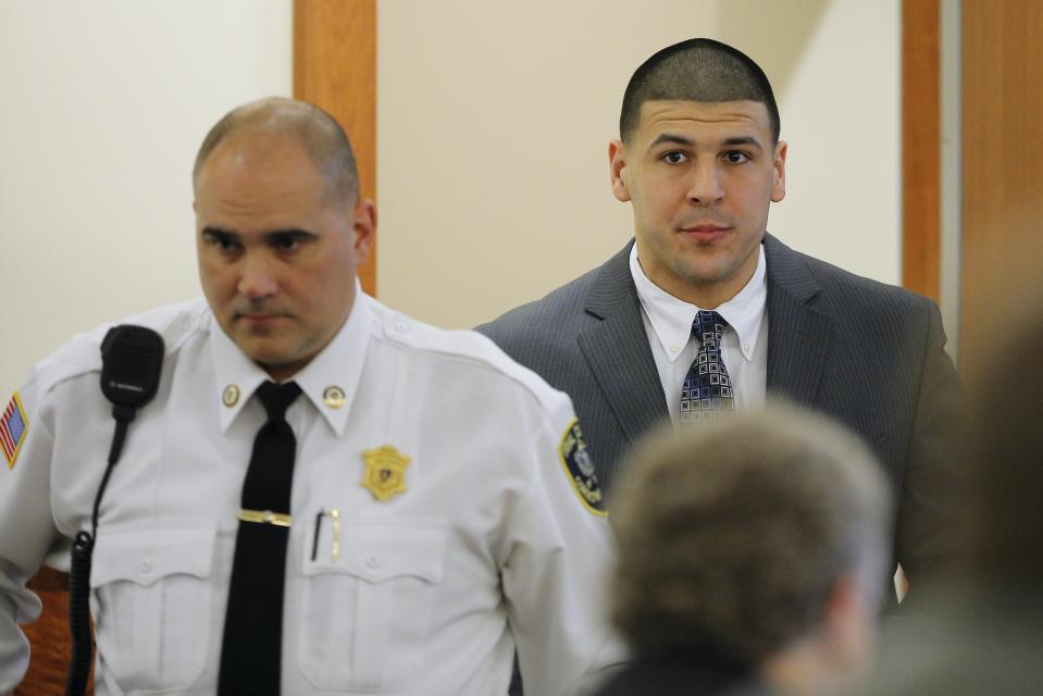 Former New England Patriots football player Aaron Hernandez arrives in the courtroom at Bristol County Superior Court in Fall River, Massachusetts April 1, 2015. Hernandez, 25, had a $41 million contract with the National Football League team but was dropped hours after his arrest in June, 2013 on murder and firearms charges in the death of Lloyd, who had been dating his fiancée's sister. Hernandez, who has pleaded not guilty, faces life in prison if convicted. REUTERS/Brian Snyder