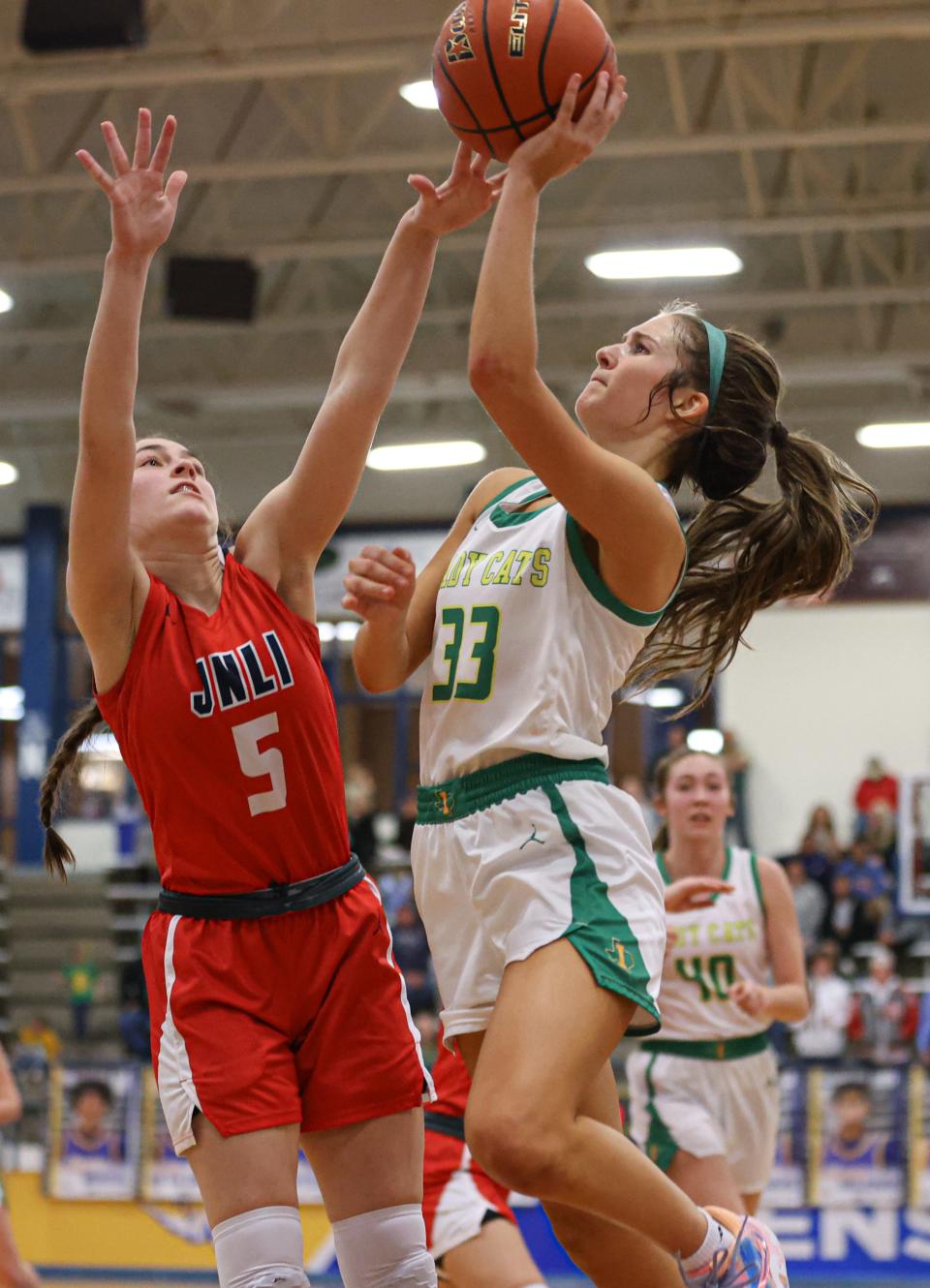 Idalou's Logan Heard (33) shoots a layup against Jim Ned in the Region I-3A semifinal girls basketball quarterfinal game, Friday, Feb. 24, 2023, at Tiger Pit in Wolfforth.