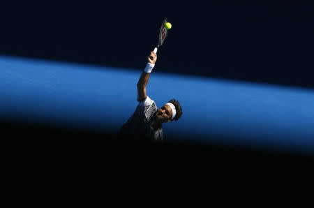 Switzerland's Roger Federer serves during his Men's singles second round match against Noah Rubin of the U.S. REUTERS/Thomas Peter