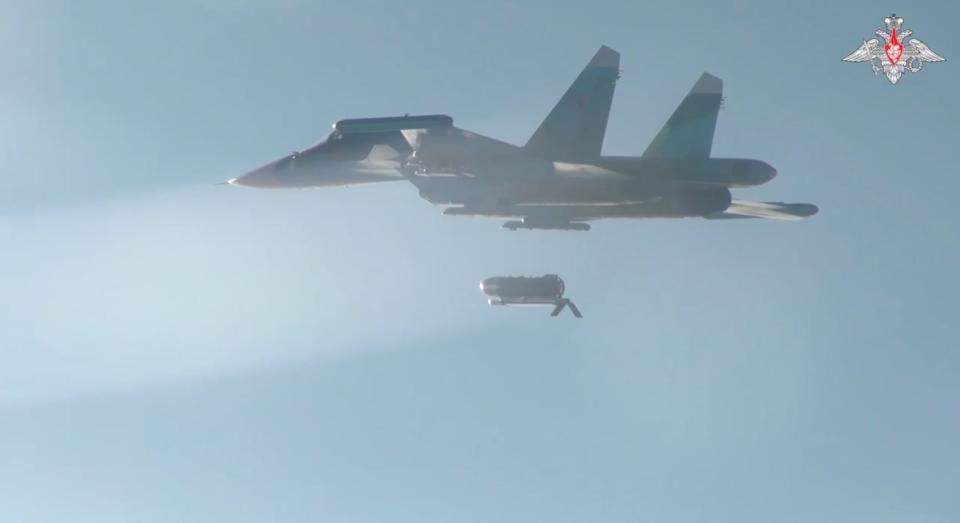 A screenshot of a fighter-bomber aircraft dropping a bomb with the Russian Ministry of Defense's logo in the top-right corner.