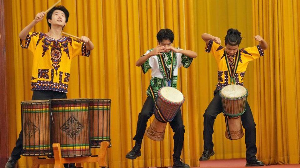 Chinese men beating traditional African drums at the Great Hall of the People in Beijing, China - Wednesday 4 September 2024 