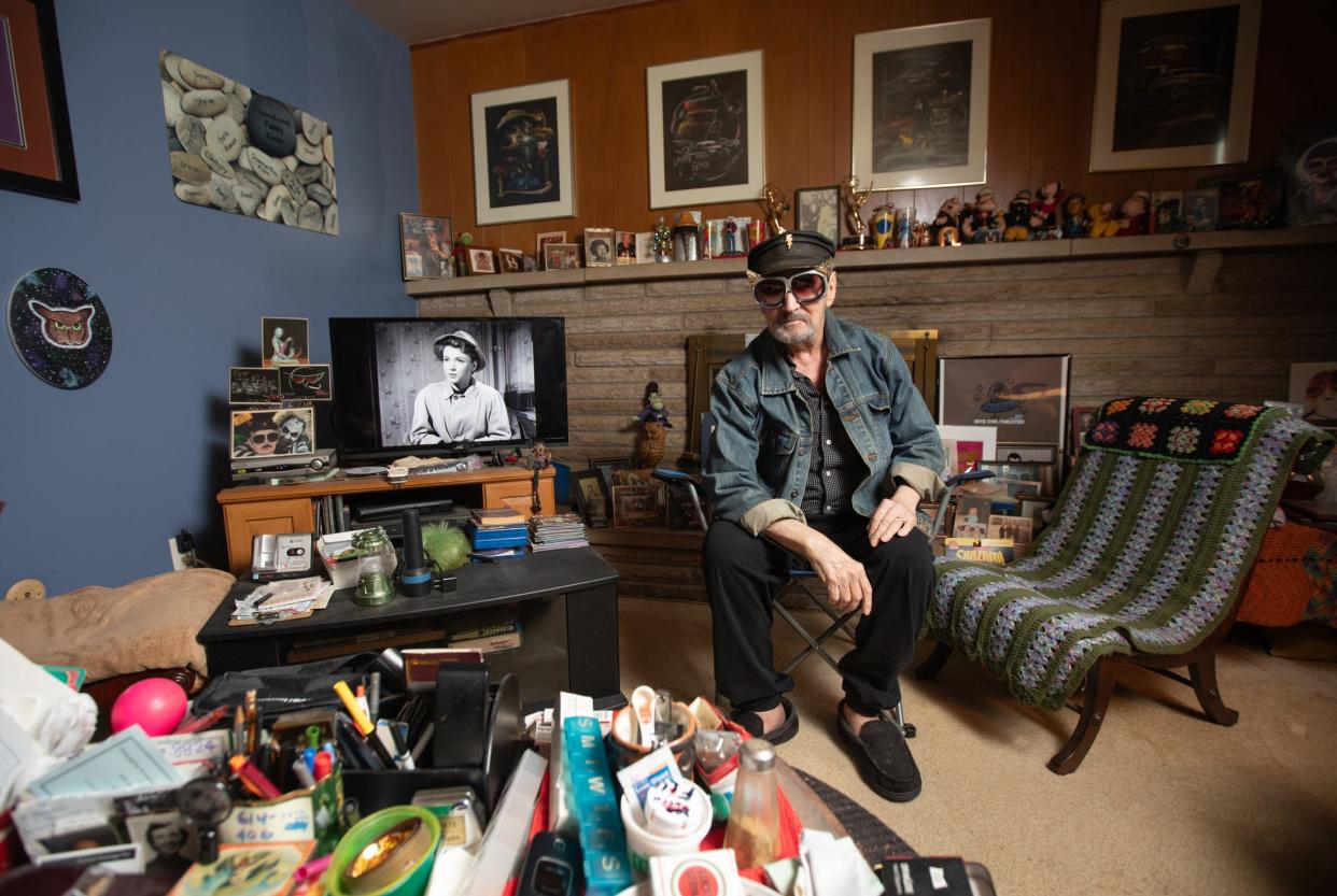 Frederick C. Peerenboom, better known as Fritz the Nite Owl, surrounded by movie memorabilia in his basement