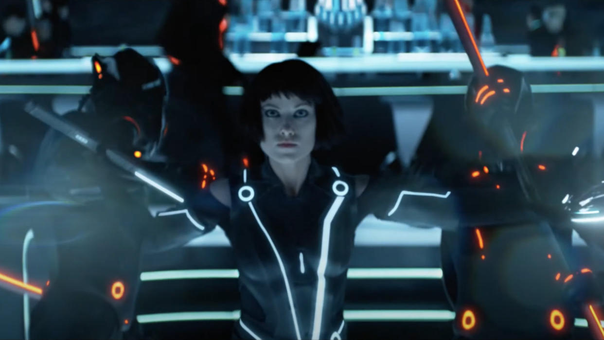  Olivia Wilde fights off two enemies in the End of Line Club in Tron: Legacy. 