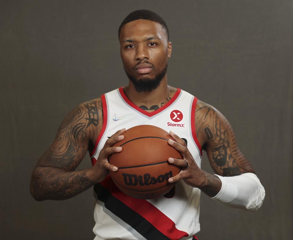 Portland Trail Blazer's Damian Lillard poses for photos during the NBA basketball team's Media Day in Portland, Ore., Monday, Sept. 27, 2021. (AP Photo/Steve Dipaola)