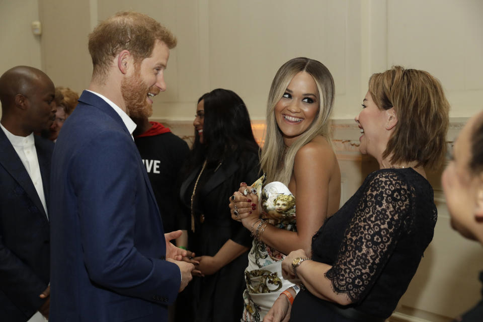 Prince Harry, Duke of Sussex speaks to British singer Rita Ora and her mum Vera Sahatciu during a reception before The Sentebale Audi Concert at Hampton Court Palace on June 11, 2019 in London, United Kingdom. (Photo by Matt Dunham – WPA Pool/Getty Images)