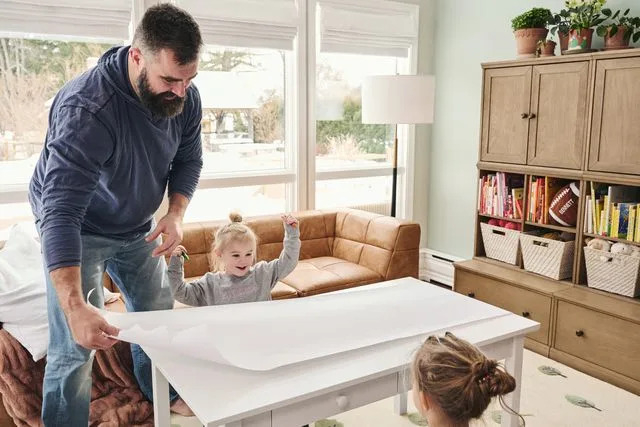 <p>courtesy of Pottery Barn Kids</p> Jason Kelce sets up drawing paper for his daughters Elliotte and Wyatt