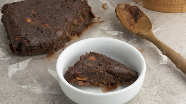 Block of tamarind being prepared for cooking