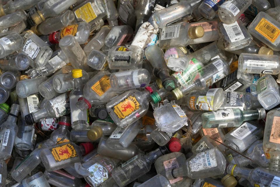 Discarded plastic nip bottles collected by cleanup volunteers.