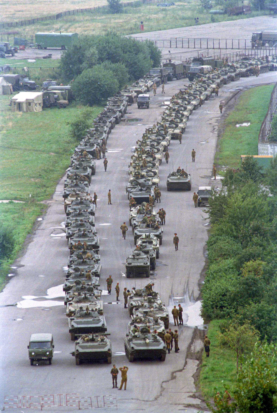 FILE - In this Tuesday, Aug. 20, 1991 file photo, a convoy of Soviet tanks holds its position near Moscow's central airfield less than two miles from the Kremlin, Russia. When a group of top Communist officials ousted Soviet leader Mikhail Gorbachev 30 years ago and flooded Moscow with tanks, the world held its breath, fearing a rollback on liberal reforms and a return to the Cold War confrontation. But the August 1991 coup collapsed in just three days, precipitating the breakup of the Soviet Union that plotters said they were trying to prevent. (AP Photo/Boris Yurchenko, File)