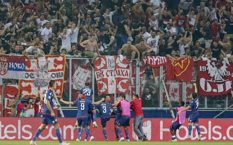 Players of Red Star Belgrade celebrate their second goal with fans during the UEFA Champions League match between FC Salzburg and Red Star Belgrade  - Credit: GETTY IMAGES