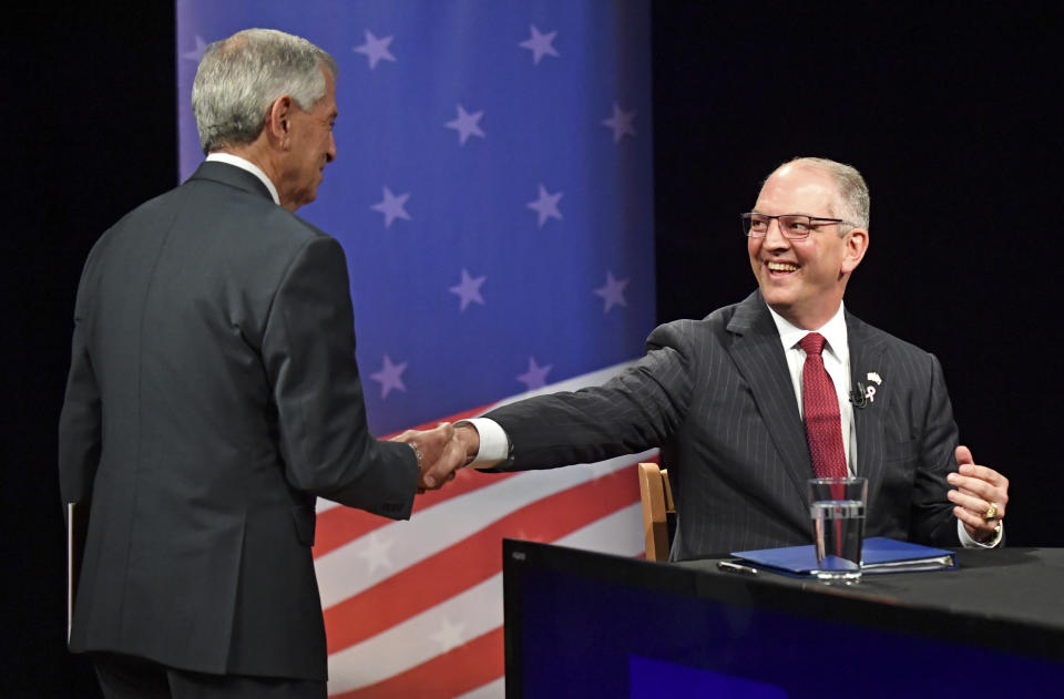 Republican candidate Eddie Rispone, left, and Democratic Louisiana Gov. John Bel Edwards shake hands on set before the start of the Louisiana Governor's runoff debate, Wednesday, Oct. 30, 2019, at Louisiana Public Broadcasting in Baton Rouge, La. (Hilary Scheinuk/The Advocate via AP)