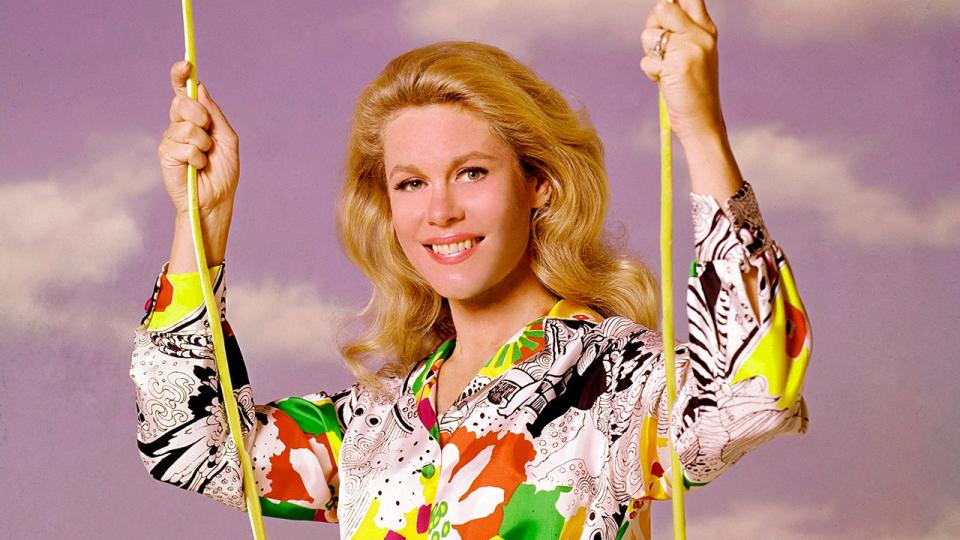 Elizabeth Montgomery smiling on a swing