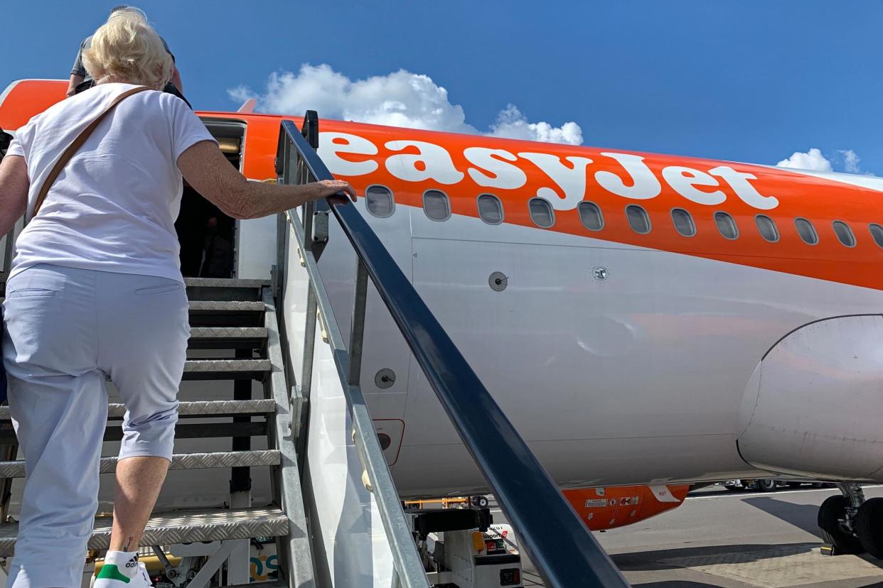 Passengers board an easyJet domestic flight at an airport in the United Kingdom on 15 June 2020 as the low cost carrier resumes flights for the first time since the March coronavirus lockdown: (Photo by -/AFP via Getty Images)