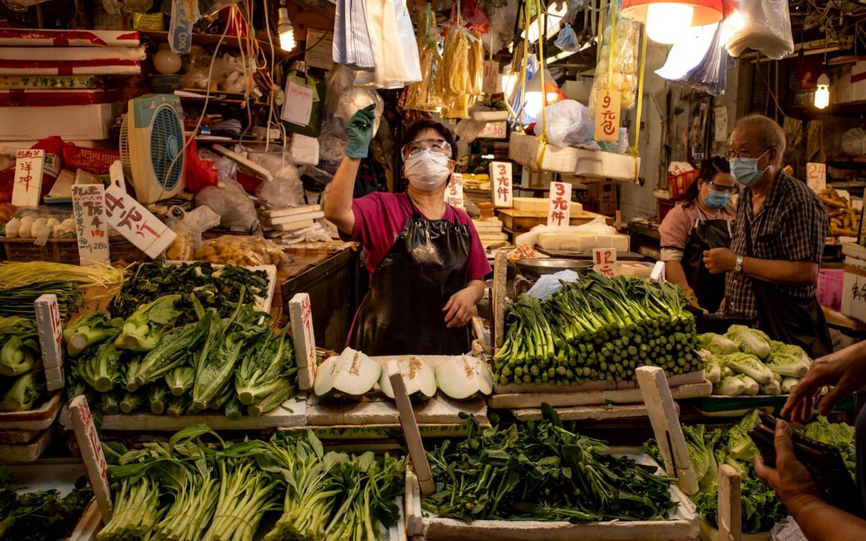 Residents wearing face masks at a wet market in Hong Kong, China. - Getty Images AsiaPac