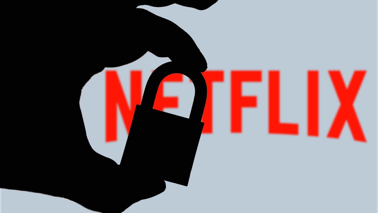  Man holding padlock in front of the Netflix logo 