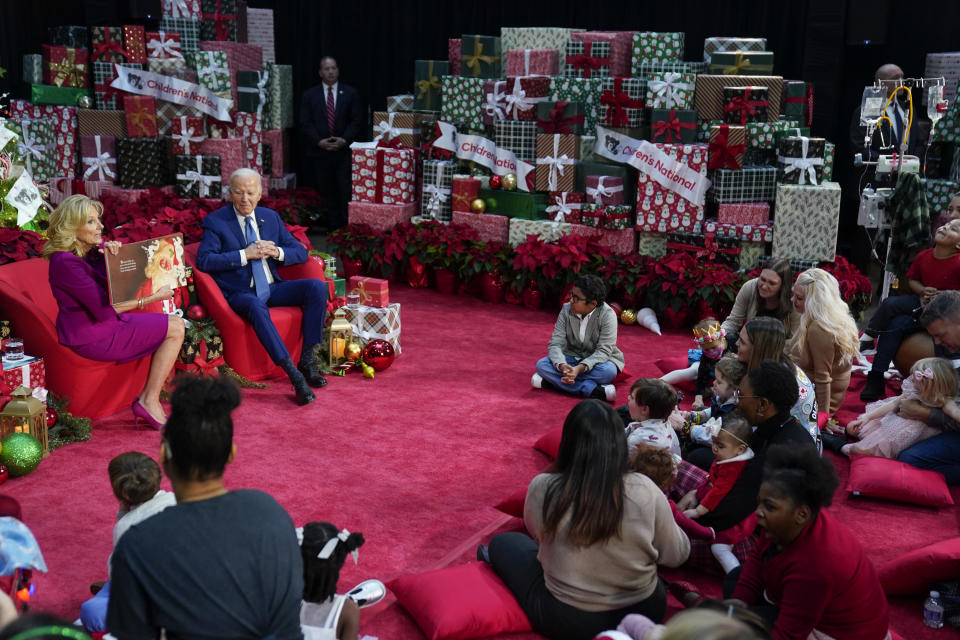 First lady Jill Biden, accompanied by President Joe Biden, reads "Twas the Night Before Christmas" at Children's National Hospital, Friday, Dec. 22, 2023, in Washington. (AP Photo/Evan Vucci)