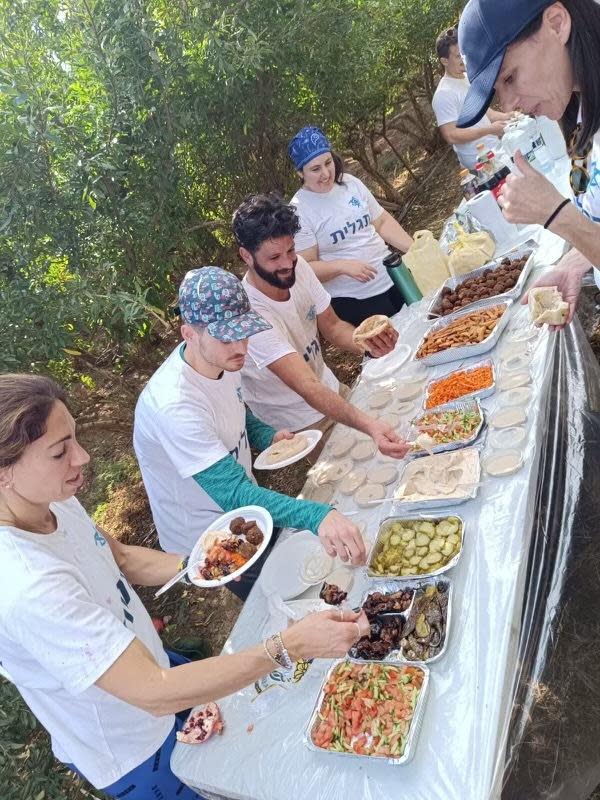 Birthright volunteers gather for lunch after a day of picking produce.  / Credit: courtesy Judy Heller