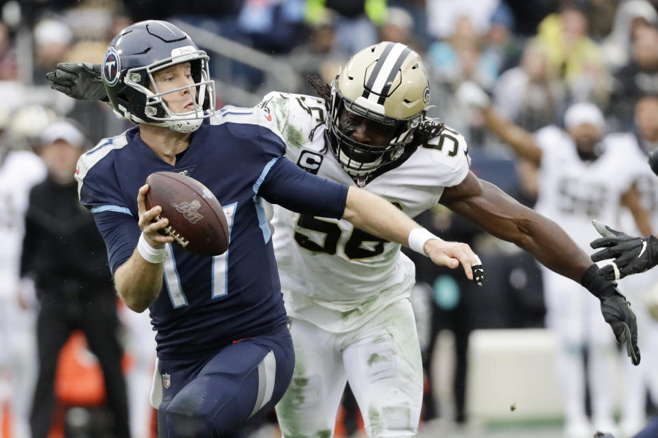 Tennessee Titans quarterback Ryan Tannehill (17) is sacked for a 10-yard loss by New Orleans Saints outside linebacker Demario Davis (56) in the first half of an NFL football game Sunday, Dec. 22, 2019, in Nashville, Tenn. (AP Photo/James Kenney)