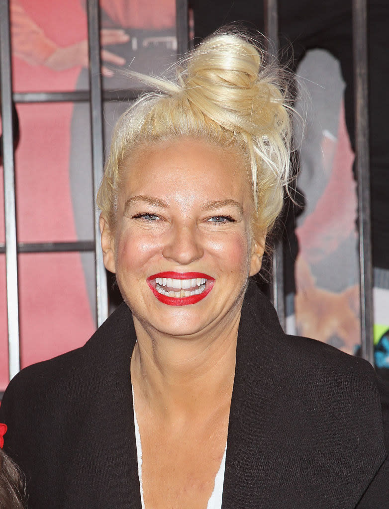 Sia smiling on a red carpet