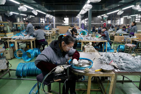 Employees work on the production line of Kent bicycles at Shanghai General Sports Co., Ltd, in Kunshan, Jiangsu Province, China, February 22, 2019. Picture taken February 22, 2019. REUTERS/Aly Song