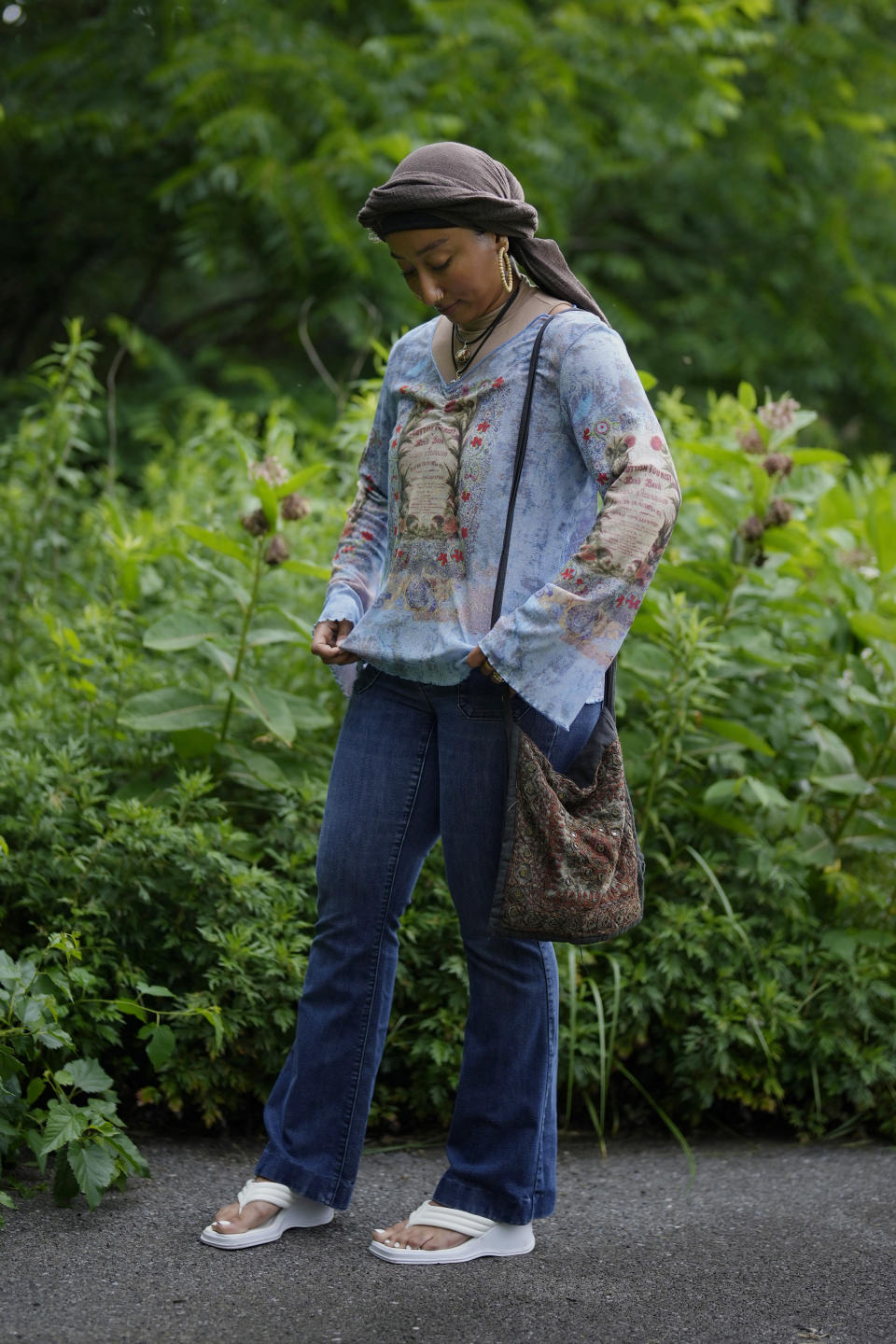 Yasmeen Bekhit, a 22-year-old graduate student, adjusts her Y2K-inspired outfit while posing for a photograph near her home in Manheim, Pa., Tuesday, June 27, 2023. If there’s one thing retailers will tell you, it’s that Gen Z hasn’t let up on early 2000s trends that are booming in popularity two decades later. (AP Photo/Matt Slocum)