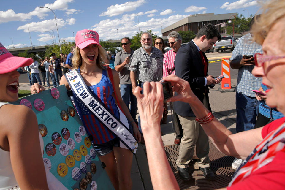 <p>Miss New Mexico 2015 Christy Waite (second from right), a supporter of Republican presidential candidate Donald Trump, poses for a photo for her mother with buttons that read “Hot Chicks for Trump” as they wait in line before the start of his rally in Albuquerque, N.M., Tuesday, May 24, 2016. (Reuters/Jonathan Ernst) </p>