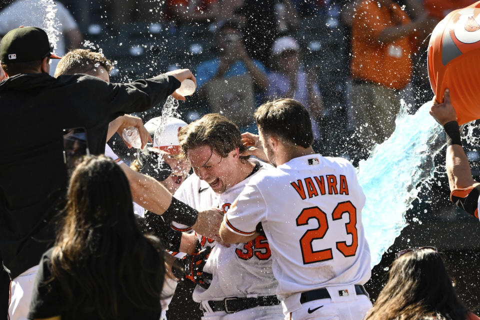 Baltimore Orioles' Adley Rutschman (35) is doused by teammates after hitting a walkoff solo home run against Oakland Athletics relief pitcher Trevor May during the ninth inning of a baseball game, Thursday, April 13, 2023, in Baltimore. (AP Photo/Terrance Williams)