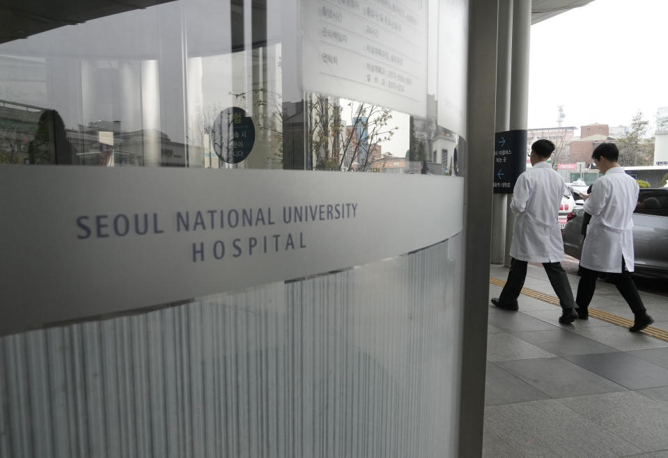 Medical workers walk to enter Seoul National University Hospital in Seoul, South Korea, Thursday, Feb. 29, 2024. South Korea’s government made a last appeal to junior doctors to end a walkout, with hours left to go before the Thursday deadline on its threats to suspend medical licenses and prosecute the strikers. (AP Photo/Ahn Young-joon)