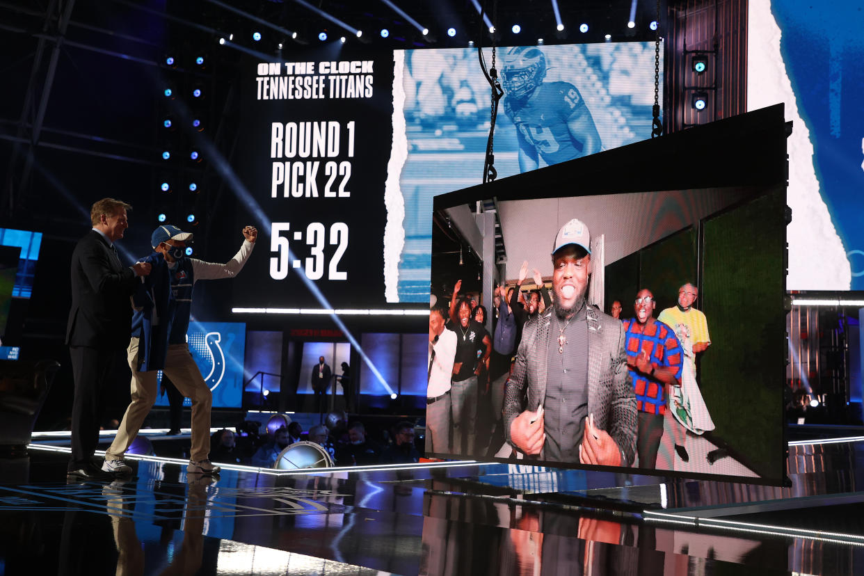 Kwity Paye is shown on a screen after being announced as the 21st draft pick with Roger Goodell and a Colts fan on stage in Cleveland looking at the screen.