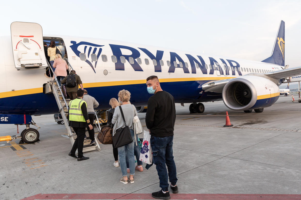 Passengers in protective face masks are seen waiting for departure of Ryanair flight at Krakow Balice Airport as the airline industry is trying to recover after global Coronavirus lockdown cut most of international passenger flights - Krakow, Poland on September 14, 2020. (Photo by Dominika Zarzycka/NurPhoto via Getty Images)