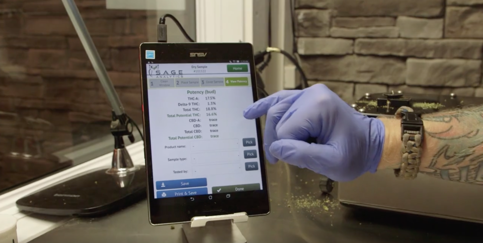 A budtender shows off product information on a tablet at the Medicine Wheel cannabis store on the Alderville First Nation. (Yahoo Finance Canada)