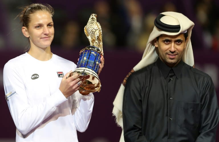 Karolina Pliskova of the Czech Republic poses for a picture with the winner's trophy after winning against Denmark's Caroline Wozniacki during their final tennis match in the WTA Qatar Total Open on February 18, 2017, in Doha