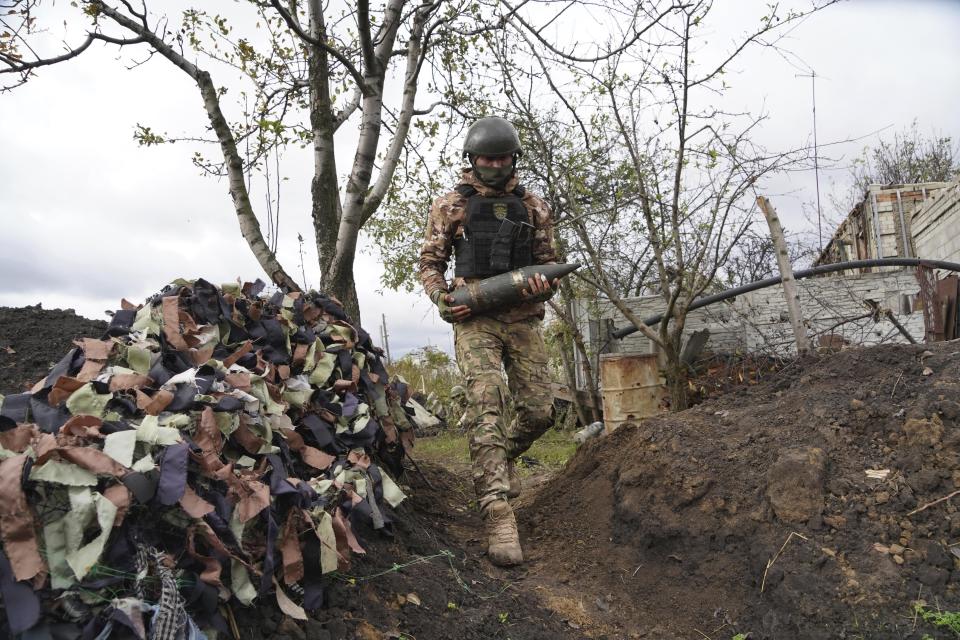 A Ukrainian soldier prepares to fire, on the front line in the Kharkiv region, Ukraine, Wednesday, Oct. 5, 2022. (AP Photo/Andrii Marienko)