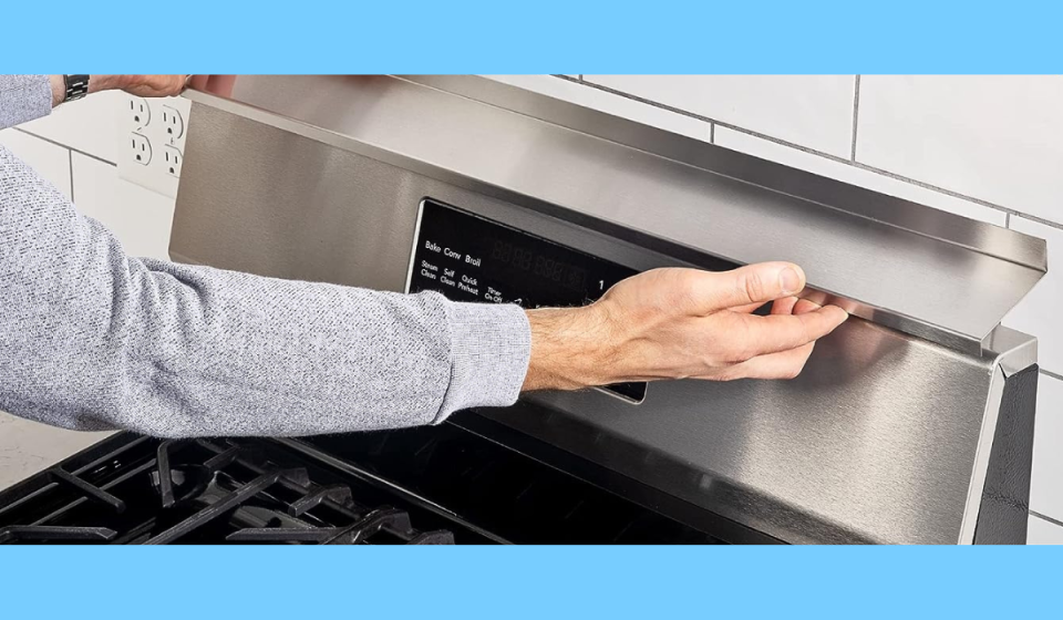 hands placing the stoveshelf on top of a stove for more kitchen storage