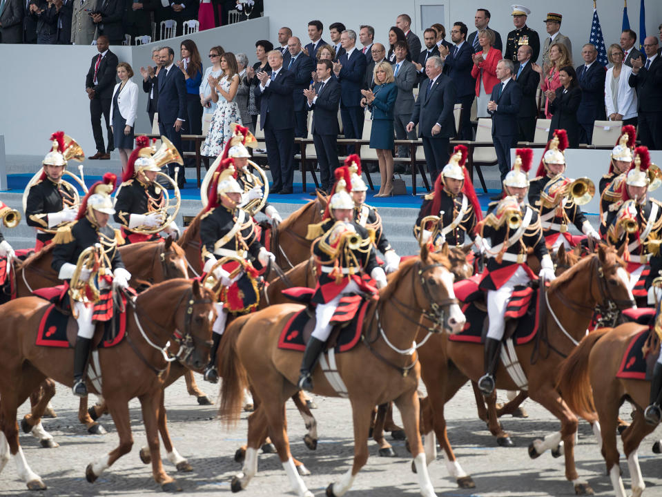 <p>President Donald Trump, center left, and first lady Melania Trump, and French President Emmanuel Macron, center, and his wife Brigitte Macron look out from the viewing stand during Bastille Day parade on the Champs Elysees avenue in Paris, Friday, July 14, 2017. (Photo: Carolyn Kaster/AP) </p>