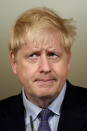 Britain's Prime Minister Boris Johnson pauses, during a coronavirus media briefing in Downing Street, London, Tuesday, Oct. 20, 2020. British Prime Minister Boris Johnson says he is imposing the highest level of coronavirus restrictions on the Greater Manchester region, after days-long negotiations between his government and local leaders who reject the measures broke down with no deal reached. (Leon Neal/Pool Photo via AP)