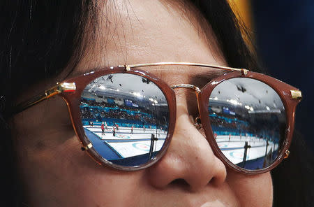 Curling - Pyeongchang 2018 Winter Olympics - Women's Round Robin - Britain v Japan - Gangneung Curling Center - Gangneung, South Korea - February 20, 2018 - Curling sheets are reflected in the sunglasses of a spectator during session 10 of the Women's Round Robin. REUTERS/Cathal McNaughton